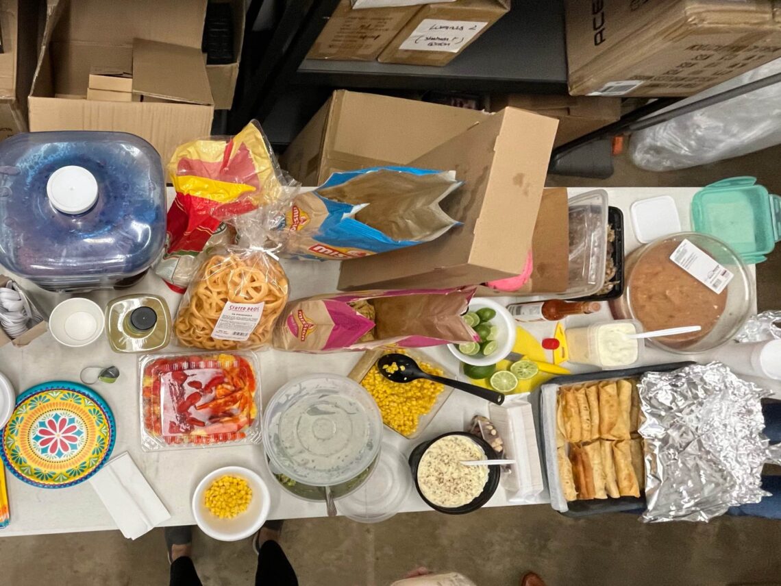 plates of different dishes on the table of potluck party